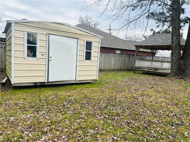 view of outbuilding featuring an outbuilding, a gazebo, and fence