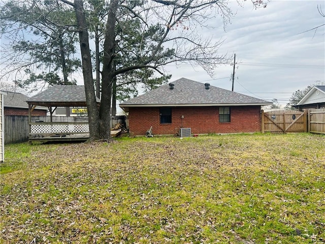 view of yard featuring a fenced backyard, a gate, cooling unit, and a gazebo