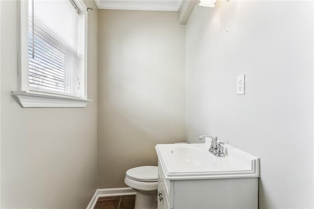 half bath with toilet, tile patterned flooring, baseboards, and vanity