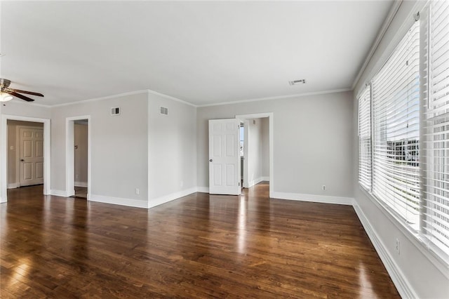 unfurnished living room featuring ornamental molding, dark wood-style flooring, visible vents, and baseboards