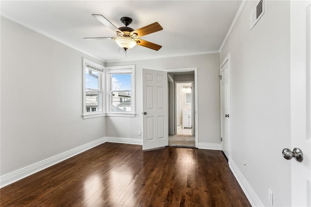 unfurnished bedroom featuring visible vents, crown molding, hardwood / wood-style flooring, and baseboards