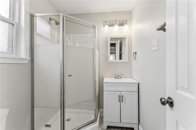 bathroom with a shower stall and vanity