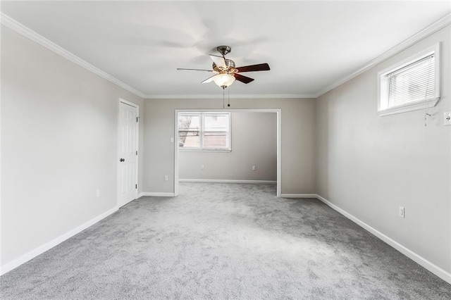 spare room featuring ornamental molding, carpet, and baseboards