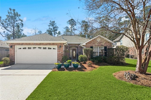 single story home featuring a garage, concrete driveway, brick siding, and a front lawn