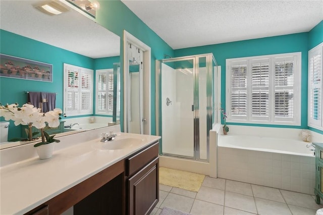 bathroom featuring a shower stall, a textured ceiling, a bath, and tile patterned floors