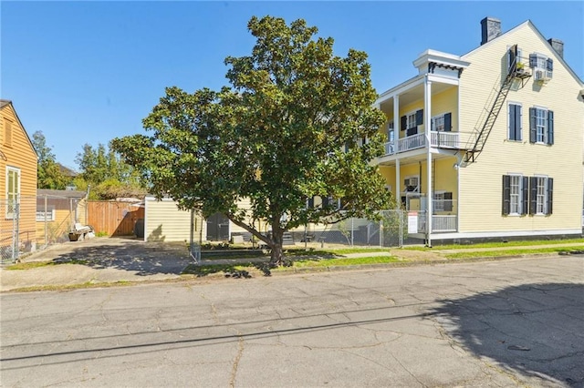 view of front of house featuring fence and a chimney