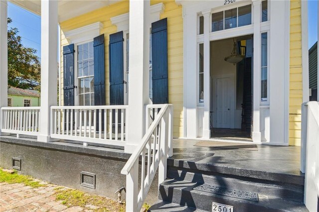 2501 Dauphine St, New Orleans, LA 70117 - view of exterior entry with a porch and crawl space