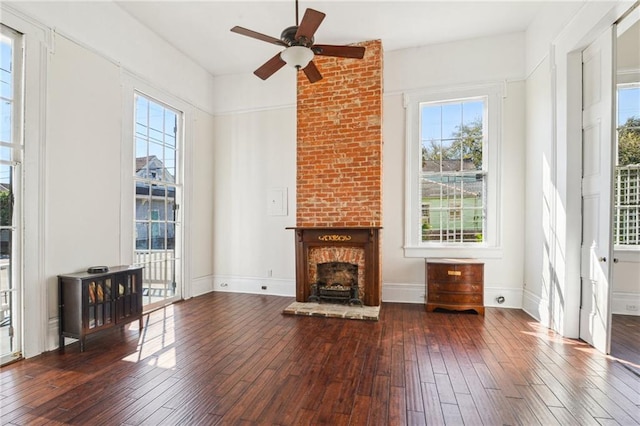 2501 Dauphine St, New Orleans, LA 70117 - unfurnished living room featuring ceiling fan, plenty of natural light, hardwood / wood-style floors, and a fireplace