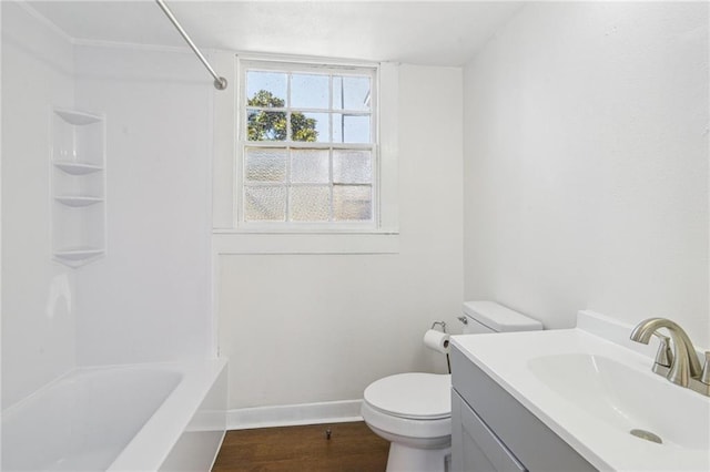 full bath with toilet, shower / washtub combination, wood finished floors, baseboards, and vanity