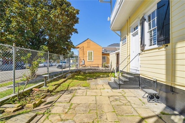 view of patio with entry steps and fence