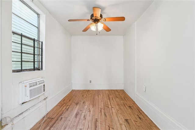 2501 Dauphine St, New Orleans, LA 70117 - unfurnished room with a ceiling fan, a wall unit AC, wood finished floors, and baseboards