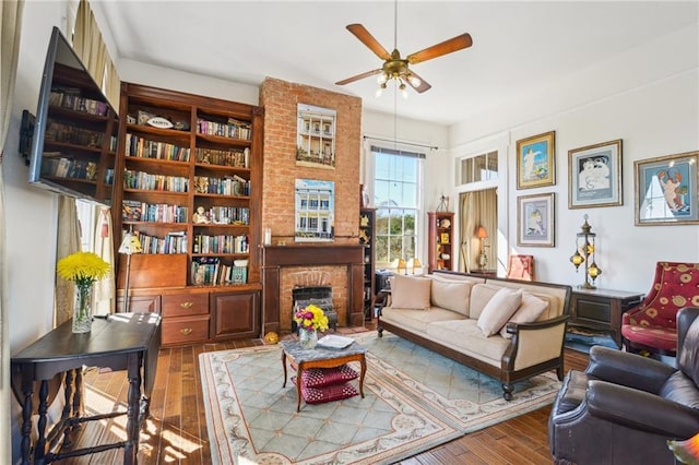 2501 Dauphine St, New Orleans, LA 70117 - living area featuring a fireplace, ceiling fan, and wood-type flooring