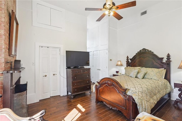 bedroom with wood finished floors, baseboards, a towering ceiling, and ceiling fan