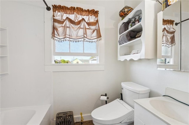 bathroom with plenty of natural light, a washtub, toilet, and vanity