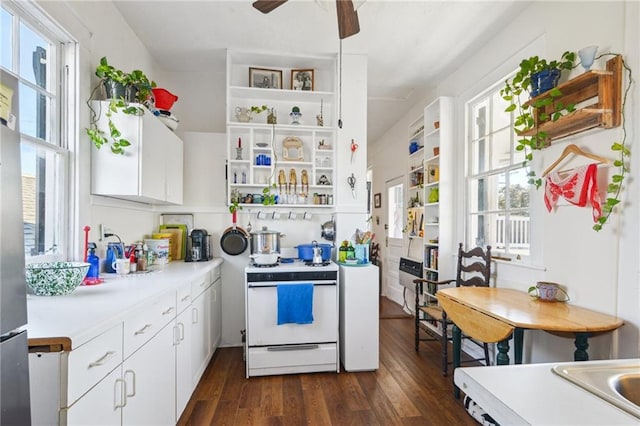 kitchen with open shelves, plenty of natural light, dark wood-style flooring, and white range with electric stovetop