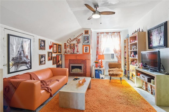 living room featuring carpet floors, a fireplace, a ceiling fan, and vaulted ceiling