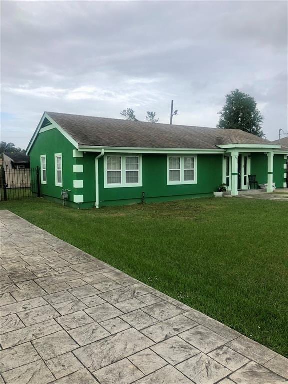 view of front of property with a front yard and fence