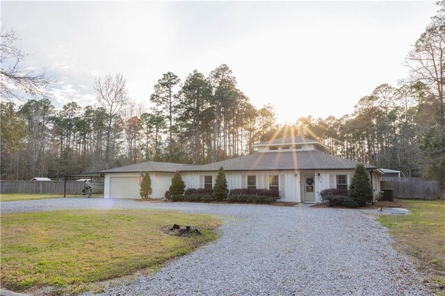 119 Ivy Dr, Covington, LA 70433 - view of front facade with a front yard, curved driveway, a garage, and fence