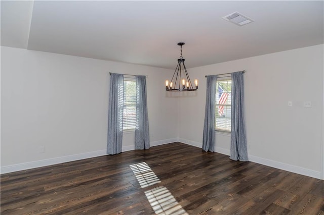 119 Ivy Dr, Covington, LA 70433 - empty room featuring an inviting chandelier, visible vents, a wealth of natural light, and wood finished floors