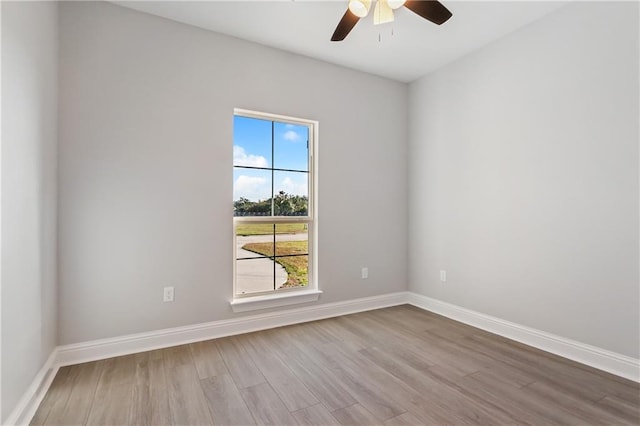 unfurnished room featuring ceiling fan, baseboards, and wood finished floors