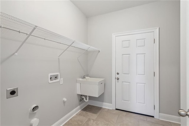 clothes washing area with laundry area, washer hookup, hookup for an electric dryer, and baseboards