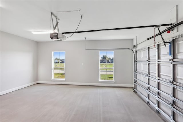 garage featuring a garage door opener and baseboards