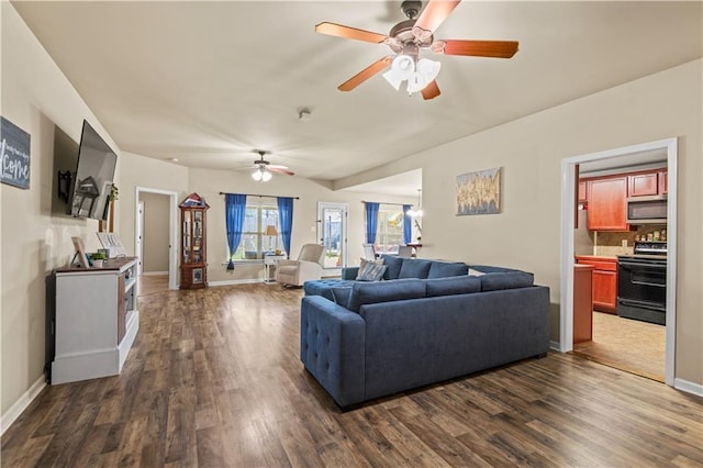 living room with baseboards and dark wood-style flooring