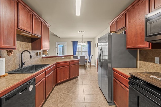 kitchen featuring light tile patterned flooring, a peninsula, a sink, visible vents, and dishwasher