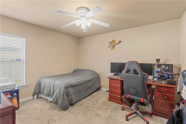 carpeted bedroom featuring baseboards and a ceiling fan