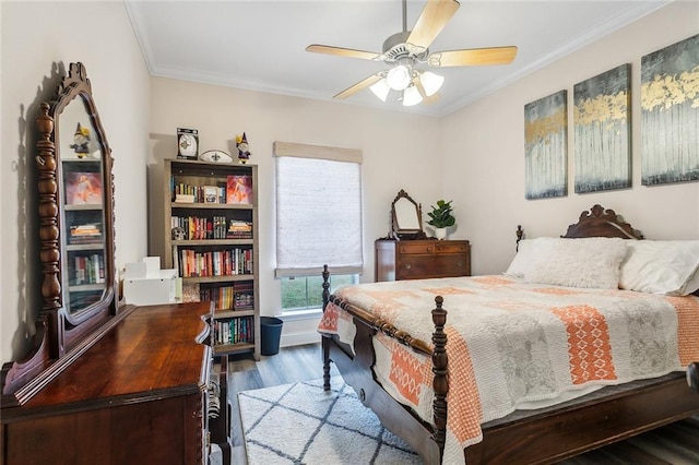 bedroom with ornamental molding, wood finished floors, and a ceiling fan