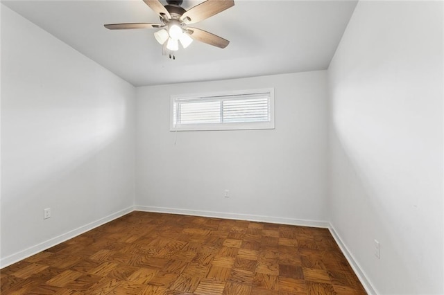 empty room featuring baseboards and a ceiling fan