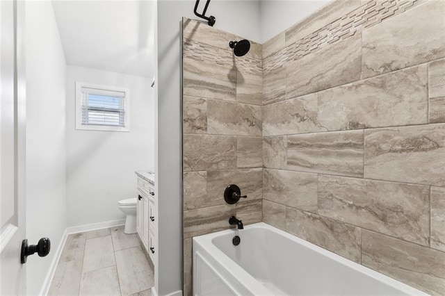 full bathroom featuring toilet, bathtub / shower combination, vanity, and baseboards