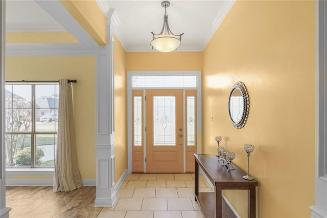 entrance foyer featuring light tile patterned flooring, crown molding, and baseboards