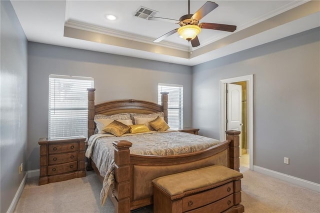 bedroom with a raised ceiling, visible vents, light carpet, and baseboards