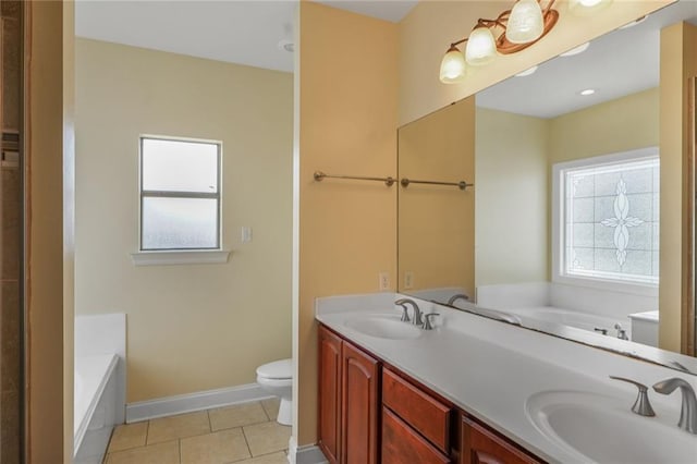 bathroom featuring a healthy amount of sunlight, a sink, and tile patterned floors