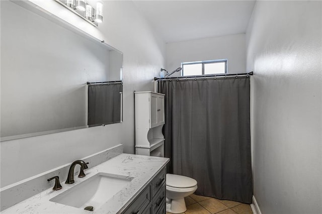 bathroom with tile patterned flooring, curtained shower, vanity, and toilet