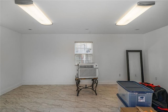 misc room with marble finish floor and baseboards