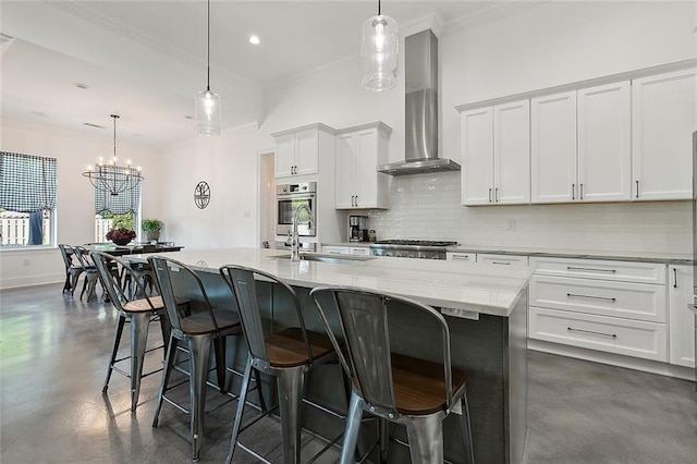 kitchen with a sink, wall chimney exhaust hood, backsplash, concrete floors, and crown molding