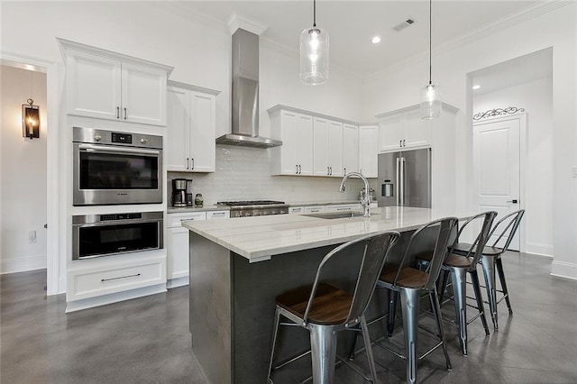 kitchen with appliances with stainless steel finishes, a sink, ornamental molding, recessed lighting, and baseboards