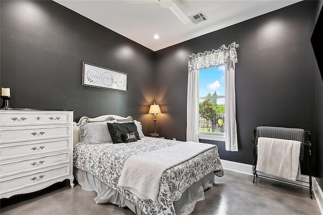 bedroom with baseboards and finished concrete flooring