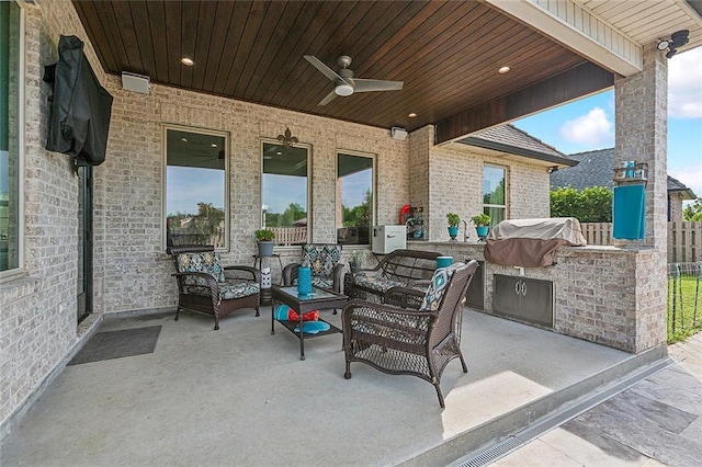 view of patio / terrace with area for grilling, outdoor lounge area, ceiling fan, and fence