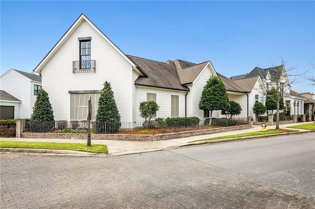 view of front of home featuring brick siding and fence