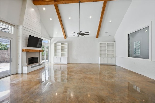 unfurnished living room featuring a large fireplace, plenty of natural light, high vaulted ceiling, and beam ceiling