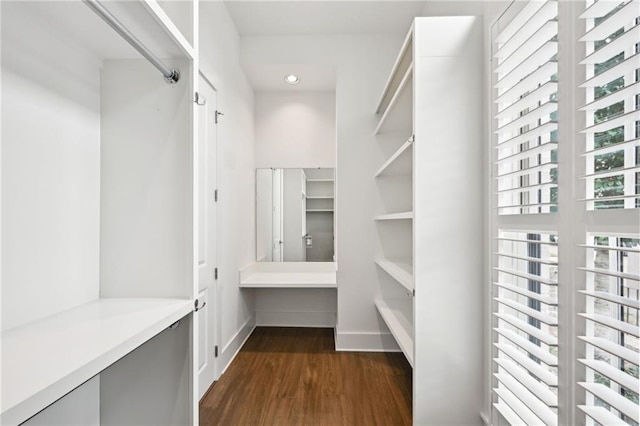 spacious closet with dark wood-style flooring