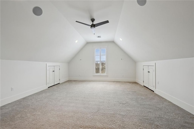 bonus room with visible vents, baseboards, lofted ceiling, ceiling fan, and carpet flooring