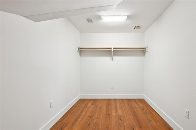 walk in closet with wood finished floors and visible vents