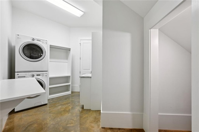 clothes washing area featuring laundry area and stacked washer / drying machine