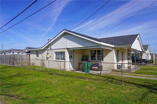 view of property exterior featuring a yard, brick siding, and a fenced front yard