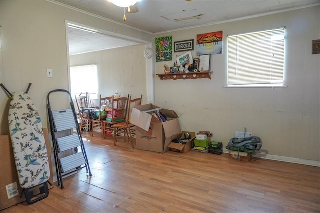 interior space with ornamental molding, ceiling fan, and wood finished floors