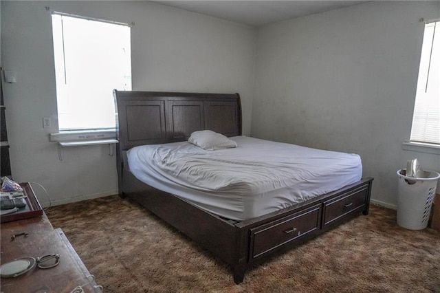 carpeted bedroom featuring baseboards